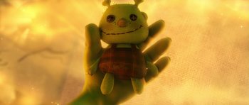 Movie still from “Shrek Forever After” (2010), directed by Mike Mitchell – A hand holding a stuffed animal with a face on it's palm; Extreme Close Up shot, Overhead angle