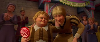 Movie still from “Shrek Forever After” (2010), directed by Mike Mitchell – A woman and a boy are posing for a picture; Medium shot, High angle