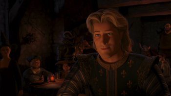 Movie still from “Shrek the Third” (2007), directed by Raman Hui – A man with blonde long hair and blue eyes in medieval garb in front of a group of people; Close Up shot, Over the shoulder angle