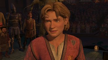 Movie still from “Shrek the Third” (2007), directed by Raman Hui – A man in a red and gold shirt is in front of a crowd of people; Close Up shot, High angle