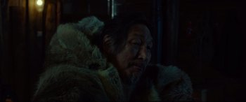 Movie still from “Siberia” (2020), directed by Abel Ferrara – An older man with a beard and a fur coat; Close Up shot, Over the shoulder angle