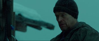 Movie still from “Siberia” (2020), directed by Abel Ferrara – A person wearing a hat; Medium shot, Low angle