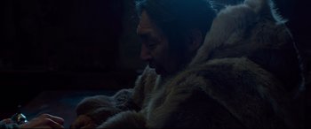 Movie still from “Siberia” (2020), directed by Abel Ferrara – A man wearing a fur coat is looking down; Close Up shot, High angle