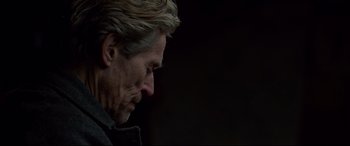 Movie still from “Siberia” (2020), directed by Abel Ferrara – A person wearing a jacket looking down; Close Up shot, Over the shoulder angle