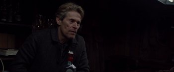 Movie still from “Siberia” (2020), directed by Abel Ferrara – A person holding a bottle of alcohol; Close Up shot, Over the shoulder angle