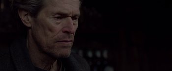 Movie still from “Siberia” (2020), directed by Abel Ferrara – A man's face in a dark room; Close Up shot, Over the shoulder angle