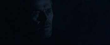 Movie still from “Siberia” (2020), directed by Abel Ferrara – A person's face in the dark; Close Up shot, Low angle