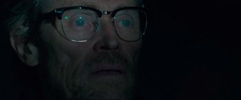 Movie still from “Siberia” (2020), directed by Abel Ferrara – A person wearing glasses; Close Up shot, Low angle