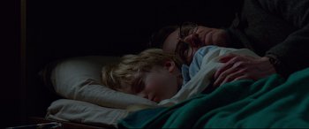Movie still from “Siberia” (2020), directed by Abel Ferrara – A man and a child sleeping in a bed; Close Up shot, Overhead angle