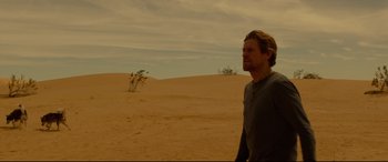 Movie still from “Siberia” (2020), directed by Abel Ferrara – A man standing in the middle of the desert; Wide shot, Low angle