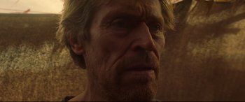 Movie still from “Siberia” (2020), directed by Abel Ferrara – A man's face in a dark room; Close Up shot, Low angle