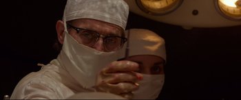 Movie still from “Siberia” (2020), directed by Abel Ferrara – A man and a woman wearing white clothes and a white mask; Close Up shot, Low angle