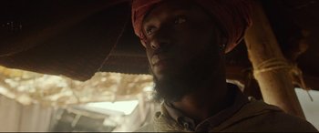 Movie still from “Siberia” (2020), directed by Abel Ferrara – A person with a beard wearing a turban; Close Up shot, Low angle