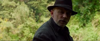 Movie still from “Siberia” (2020), directed by Abel Ferrara – A person wearing a hat and a jacket; Close Up shot, Low angle