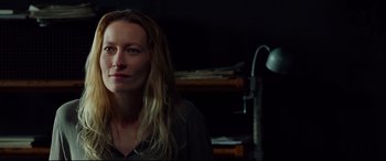 Movie still from “Siberia” (2020), directed by Abel Ferrara – A person sitting in a dark room; Close Up shot, Over the shoulder angle