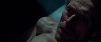 Movie still from “Siberia” (2020), directed by Abel Ferrara – A man's face in a dark room; Close Up shot, Overhead angle
