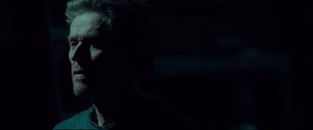 Movie still from “Siberia” (2020), directed by Abel Ferrara – A man with dark hair is looking at the camera; Close Up shot, Low angle