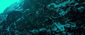 Movie still from “Siberia” (2020), directed by Abel Ferrara – View of a rock face with snow on it; Extreme Wide shot, Overhead angle