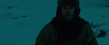 Movie still from “Siberia” (2020), directed by Abel Ferrara – A man wearing a fur hat and a coat; Close Up shot, Low angle