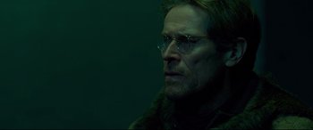 Movie still from “Siberia” (2020), directed by Abel Ferrara – A person wearing glasses and a fur coat; Close Up shot, Low angle