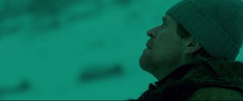 Movie still from “Siberia” (2020), directed by Abel Ferrara – A man looking up at the sky in a dark room; Close Up shot, Low angle