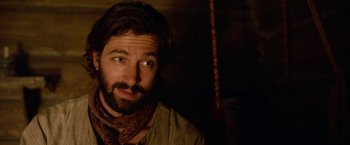 Movie still from “A Boy Called Christmas” (2021), directed by Gil Kenan – A man with long hair and a beard wearing a neck scarf; Close Up shot, Over the shoulder angle