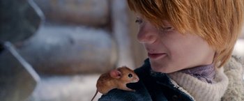 Movie still from “A Boy Called Christmas” (2021), directed by Gil Kenan – A woman holding a mouse on her shoulder; Close Up shot, Over the shoulder angle