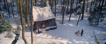 Movie still from “A Boy Called Christmas” (2021), directed by Gil Kenan – An old log cabin in the middle of the snow; Extreme Wide shot, High angle