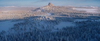 Movie still from “A Boy Called Christmas” (2021), directed by Gil Kenan – A snowy hill with a castle on top of it; Extreme Wide shot, High angle