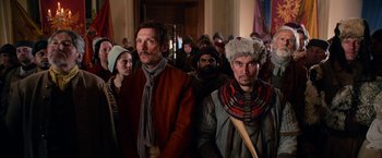 Movie still from “A Boy Called Christmas” (2021), directed by Gil Kenan – A group of people standing in front of a crowd; Medium shot, Over the shoulder angle