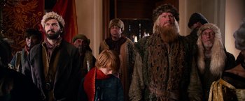 Movie still from “A Boy Called Christmas” (2021), directed by Gil Kenan – A group of people dressed up in costumes; Medium shot, Over the shoulder angle