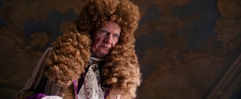 Movie still from “A Boy Called Christmas” (2021), directed by Gil Kenan – An old man with a very long curly brown hair; Medium shot, Over the shoulder angle