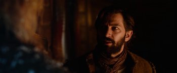 Movie still from “A Boy Called Christmas” (2021), directed by Gil Kenan – A man with a beard is looking into the distance; Close Up shot, Over the shoulder angle