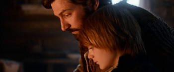 Movie still from “A Boy Called Christmas” (2021), directed by Gil Kenan – A man and a girl are looking at each other; Close Up shot, Low angle