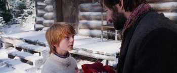 Movie still from “A Boy Called Christmas” (2021), directed by Gil Kenan – A man and a boy are talking in the snow; Close Up shot, Over the shoulder angle