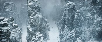 Movie still from “A Boy Called Christmas” (2021), directed by Gil Kenan – A person is skiing down a snow covered path; Extreme Wide shot, High angle