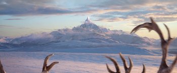 Movie still from “A Boy Called Christmas” (2021), directed by Gil Kenan – A mountain with a snow covered peak in the background; Extreme Wide shot, Low angle