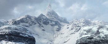 Movie still from “A Boy Called Christmas” (2021), directed by Gil Kenan – A mountain with a snow covered peak in the background; Extreme Wide shot, Low angle