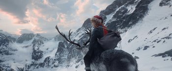 Movie still from “A Boy Called Christmas” (2021), directed by Gil Kenan – A person riding a reindeer in the snow; Wide shot, Low angle