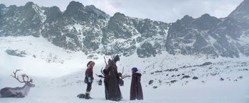 Movie still from “A Boy Called Christmas” (2021), directed by Gil Kenan – A group of people standing on top of a snow covered slope; Wide shot, Low angle