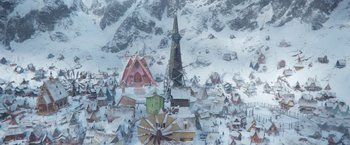 Movie still from “A Boy Called Christmas” (2021), directed by Gil Kenan – An aerial view of a town with snow on the ground; Extreme Wide shot, High angle
