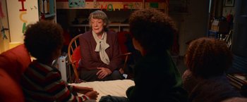 Movie still from “A Boy Called Christmas” (2021), directed by Gil Kenan – An older woman sitting on a chair in front of a young boy; Medium shot, Over the shoulder angle