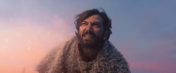 Movie still from “A Boy Called Christmas” (2021), directed by Gil Kenan – A man with long hair and a beard is wearing a fur coat; Close Up shot, Low angle