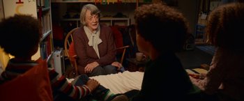 Movie still from “A Boy Called Christmas” (2021), directed by Gil Kenan – An older woman sitting in a chair talking to a young boy; Medium shot, Over the shoulder angle