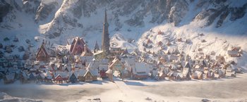 Movie still from “A Boy Called Christmas” (2021), directed by Gil Kenan – A snowy town with a church steeple in the background; Extreme Wide shot, High angle