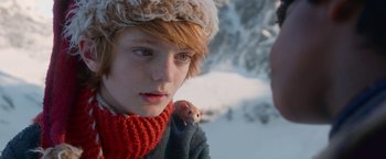 Movie still from “A Boy Called Christmas” (2021), directed by Gil Kenan – A person holding a small animal in their hand; Close Up shot, Low angle