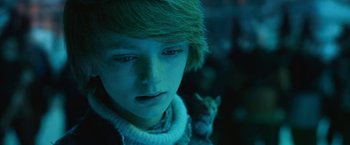 Movie still from “A Boy Called Christmas” (2021), directed by Gil Kenan – A young boy with a cat in the background; Close Up shot, Low angle
