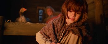Movie still from “A Boy Called Christmas” (2021), directed by Gil Kenan – A young girl is wrapped up in a blanket; Close Up shot, Low angle