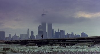Movie still from “Sid and Nancy” (1986), directed by Alex Cox – A person walking on a pier in front of a city skyline; Extreme Wide shot, Low angle
