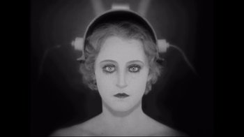 Movie still from “Side by Side” (2012), directed by Christopher Kenneally – A black and white photo of a woman with headphones; Close Up shot, Overhead angle